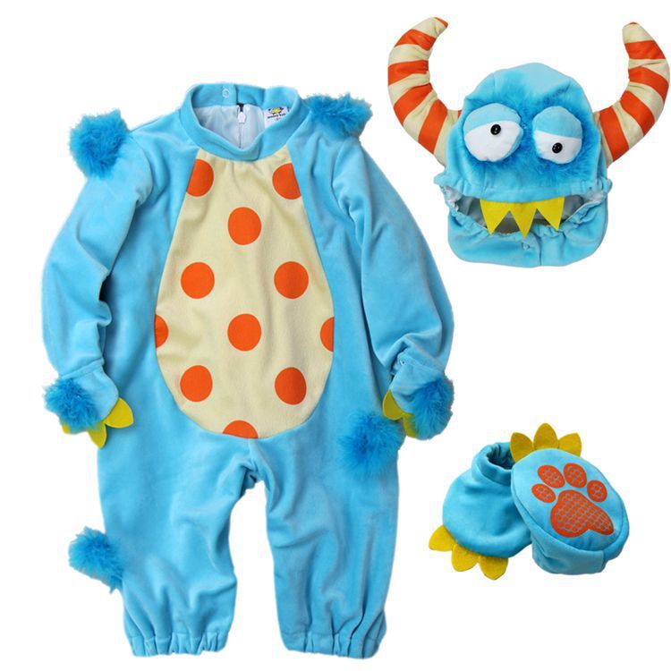 Blue monster-themed baby onesie with orange polka dots, matching hat, and booties on a white background.